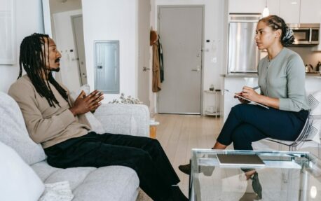 Two individuals in a therapy session.