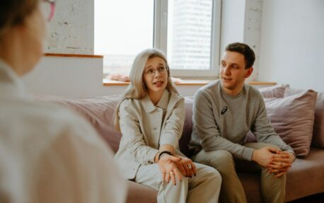 Three individuals in a therapy session.