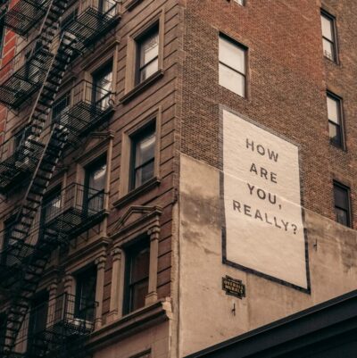A building with a sign that says "How are you, really?".