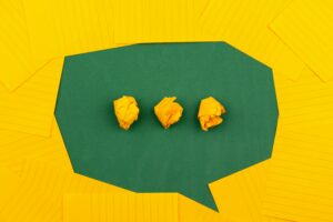 A green sms bubble on a yellow background with the context of staying in touch with a friend with a mental health condition.